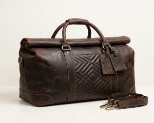 Brown genuine leather travel duffel bag with handles and detachable shoulder strapBrown genuine leather travel duffel bag with handles and detachable shoulder strap
