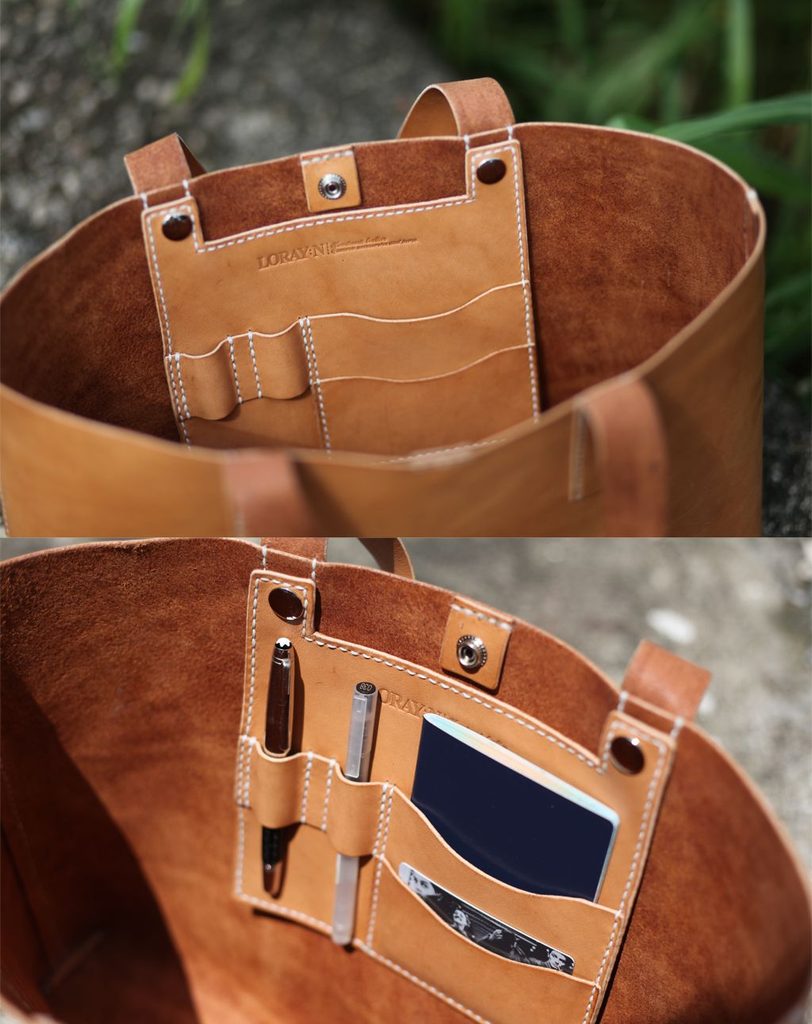 Interior organizer pockets in a leather messenger bag for pens and cards