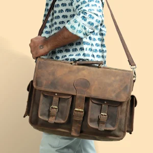 Men's leather messenger bag with front buckle pockets, worn cross-body
